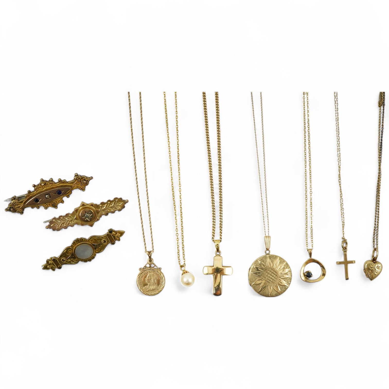 A collection of jewels, comprising: two cross pendants; a heart-shaped locket pendant; a circular locket pendant engraved with a sunflower; a pendant set with a sapphire; a diamond panel brooch; and a sapphire and diamon